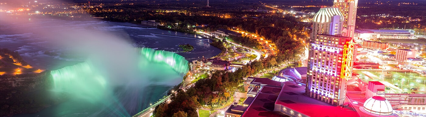 Fallsview Casino with the Horseshoe Falls illuminated at night